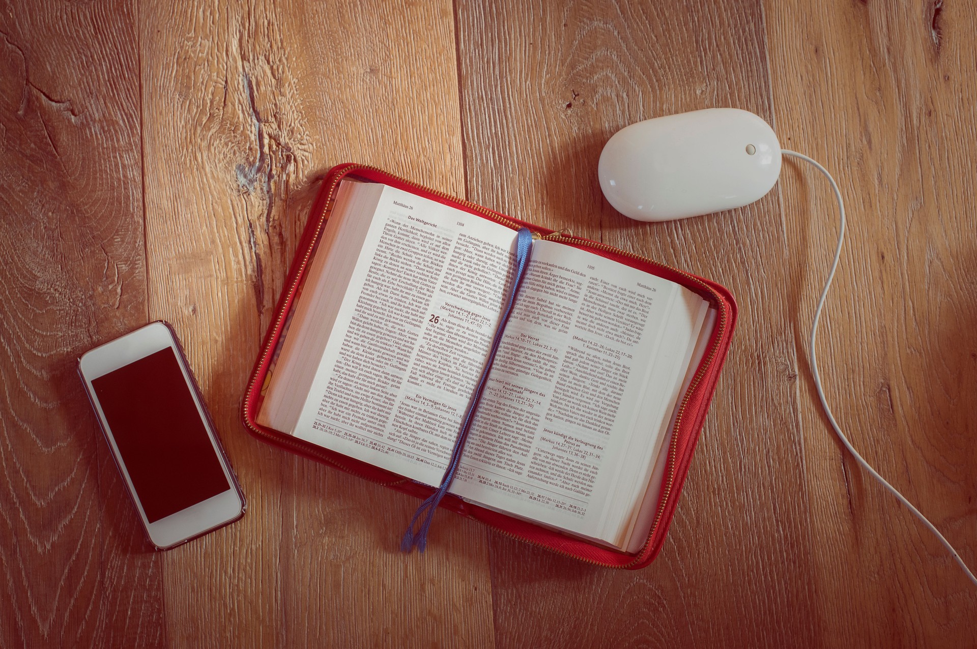 Open bible, mobile phone, computer mouse