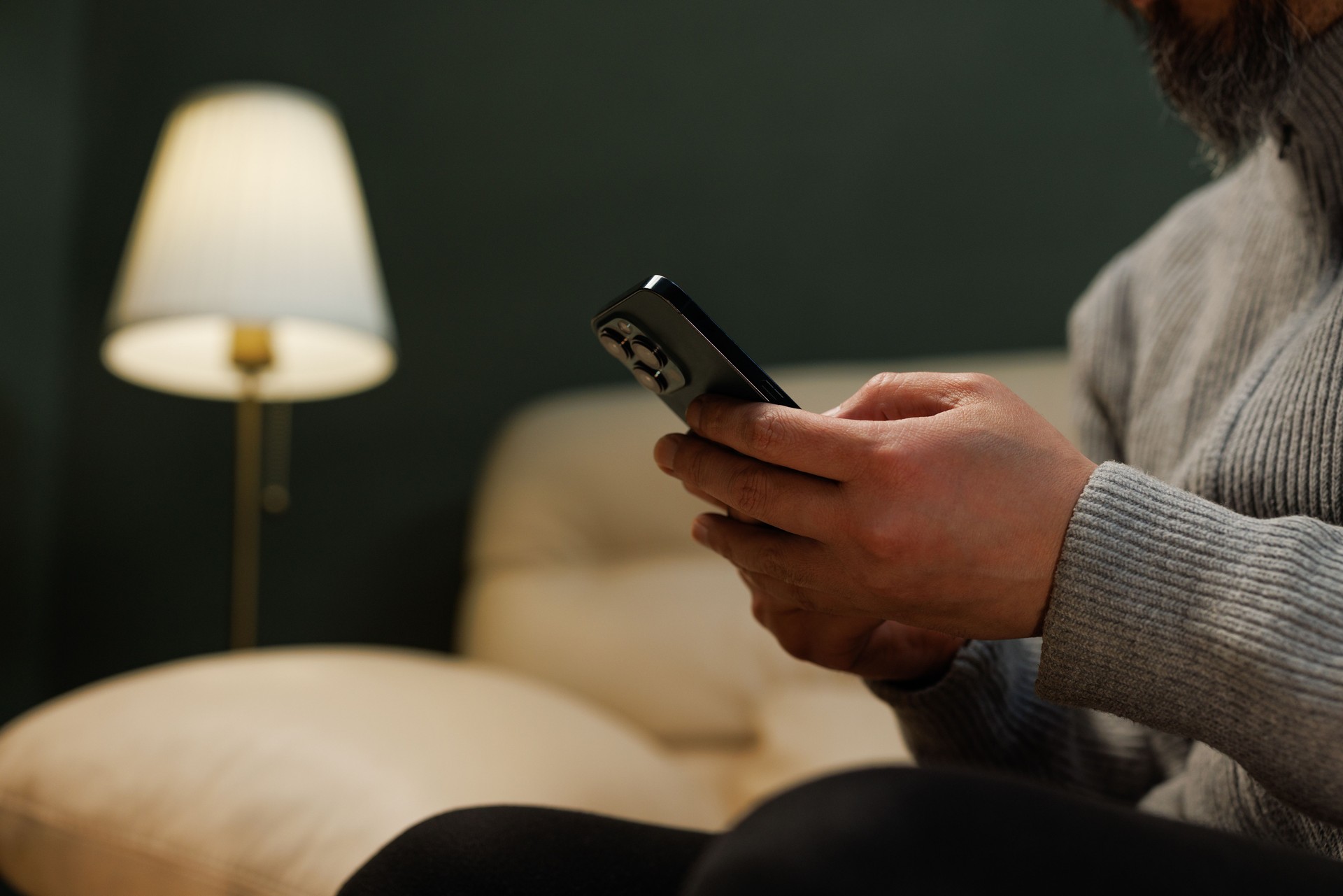 Male hands typing on smartphone